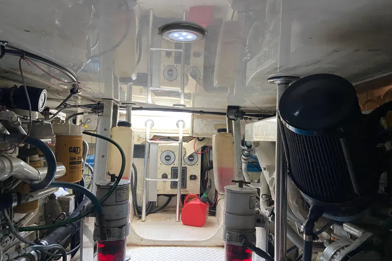 Slide: The Image of Engine room of a 2001 Egg Harbor 37 Convertible boat, showcasing mechanical components. - 44