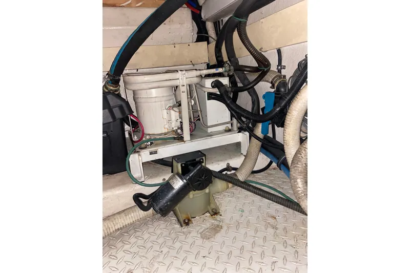 Slide: The Image of Engine room of 2001 Egg Harbor 37 Convertible with visible hoses and machinery. - 46