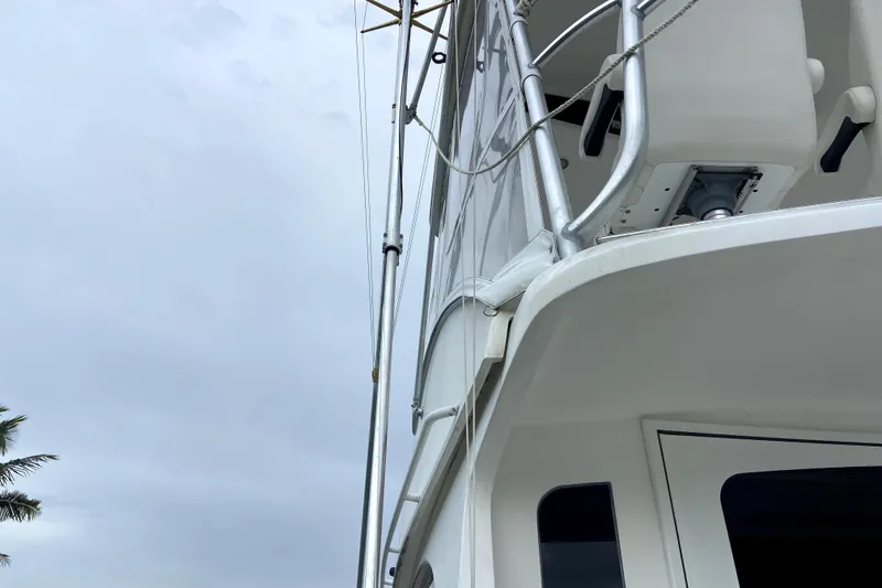 Slide: The Image of 2001 Egg Harbor 37 Convertible yacht, partial view with railing and cloudy sky. - 5