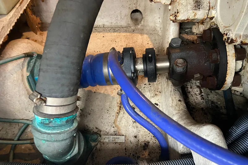 Slide: The Image of Engine compartment of a 2001 Egg Harbor 37 Convertible boat, showing hoses and mechanical components. - 50