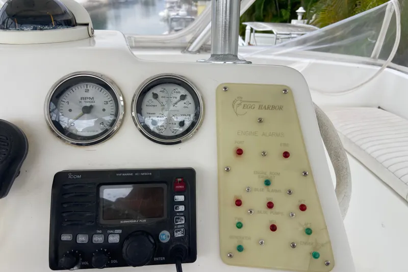 Slide: The Image of Control panel of a 2001 Egg Harbor 37 Convertible boat with gauges and alarms. - 54