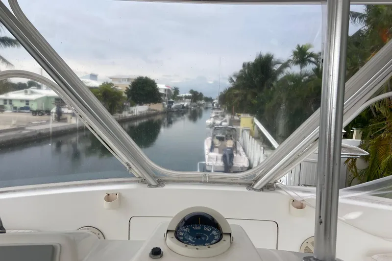 Slide: The Image of View from 2001 Egg Harbor 37 Convertible boat, overlooking a serene canal with docked boats. - 57