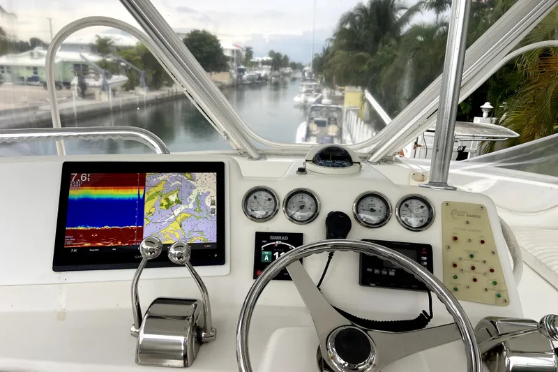 Slide: The Image of Cockpit view of 2001 Egg Harbor 37 Convertible with navigation instruments and steering wheel. - 6