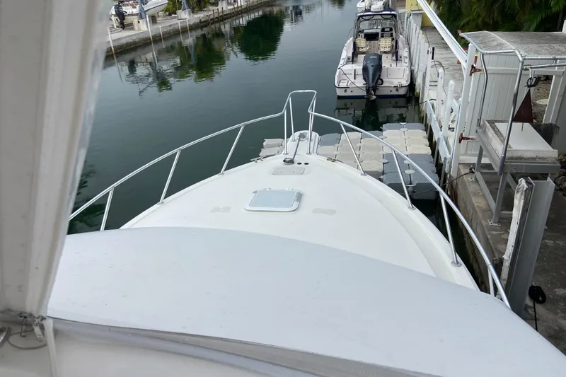 Slide: The Image of Bow view of 2001 Egg Harbor 37 Convertible docked in a marina. - 63
