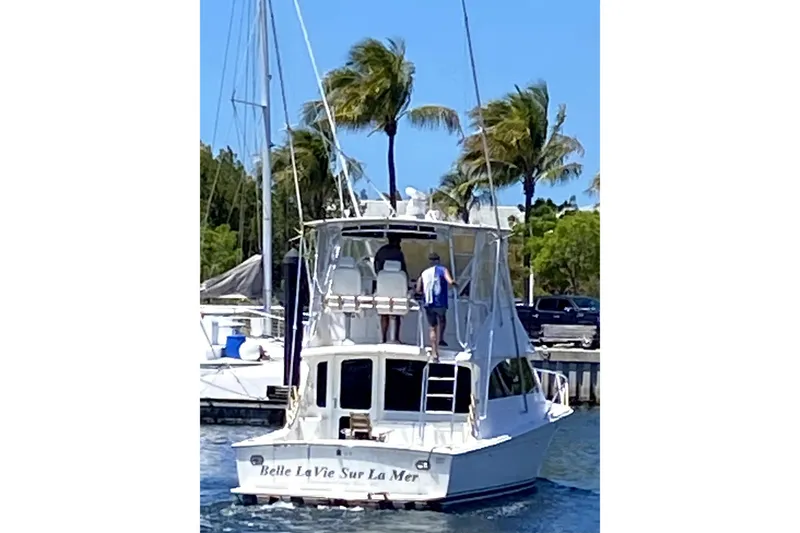 Slide: The Image of 2001 Egg Harbor 37 Convertible yacht cruising near palm trees and marina. - 70