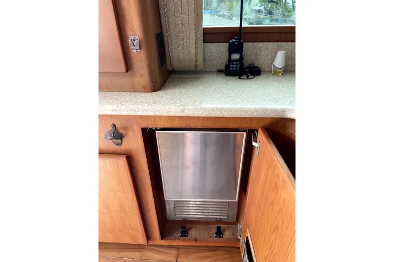 Slide: The Image of Interior of 2001 Egg Harbor 37 Convertible yacht with wooden cabinetry and built-in appliances. - 8