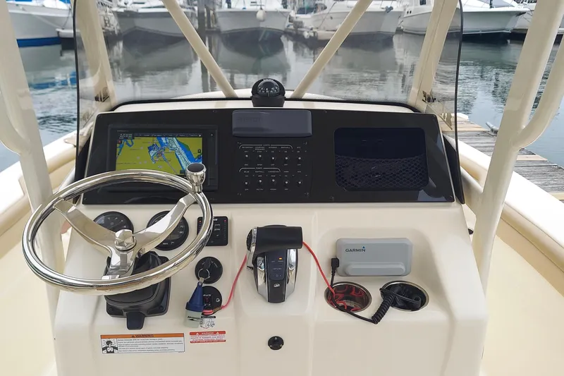 Slide: The Image of 2020 Scout 215 XSF boat dashboard with navigation system and steering wheel. - 2