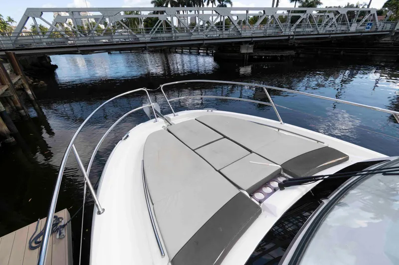 Slide: The Image of 2019 Jeanneau Leader 10.5 boat docked near a bridge, featuring spacious deck seating. - 11