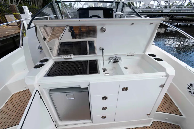 Slide: The Image of Outdoor kitchen on 2019 Jeanneau Leader 10.5 boat with grill, sink, and storage. - 13