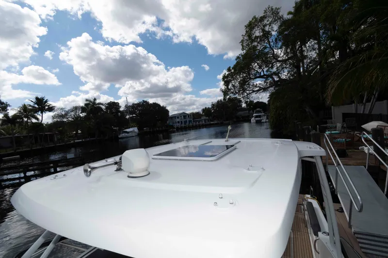 Slide: The Image of 2019 Jeanneau Leader 10.5 boat docked on a scenic waterway under a cloudy sky. - 14