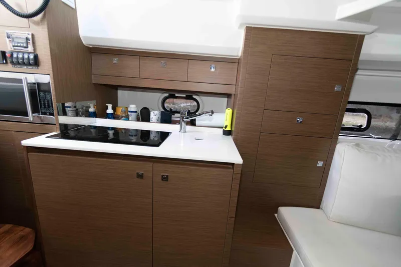 Slide: The Image of 2019 Jeanneau Leader 10.5 yacht interior with modern kitchen and wooden cabinetry. - 18