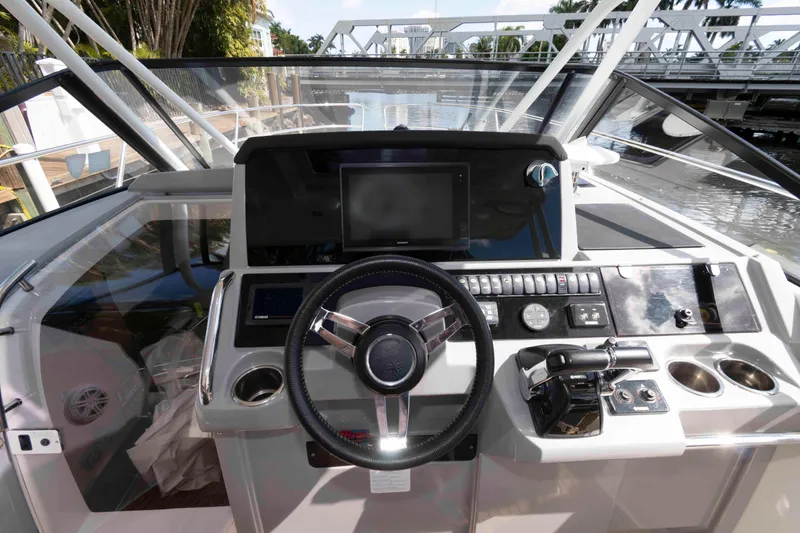 Slide: The Image of Cockpit view of 2019 Jeanneau Leader 10.5 boat with modern controls and steering wheel. - 5