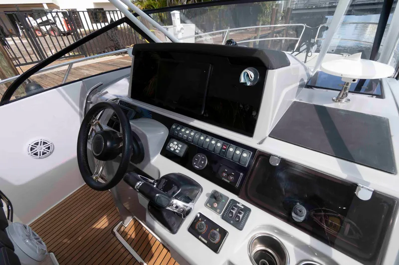 Slide: The Image of Cockpit of 2019 Jeanneau Leader 10.5 boat with modern controls and steering wheel. - 7