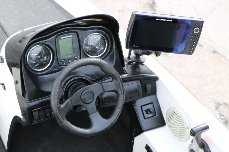 Slide: The Image of 2007 Skeeter SX180 boat dashboard with steering wheel, gauges, and Humminbird Helix 10 fish finder. - 18