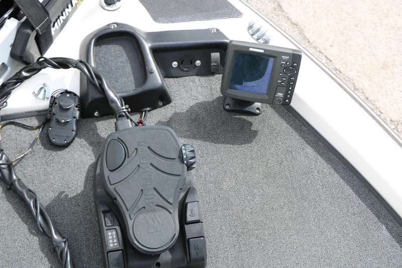 Slide: The Image of 2007 Skeeter SX180 boat dashboard with fishfinder and foot pedal controls. - 21