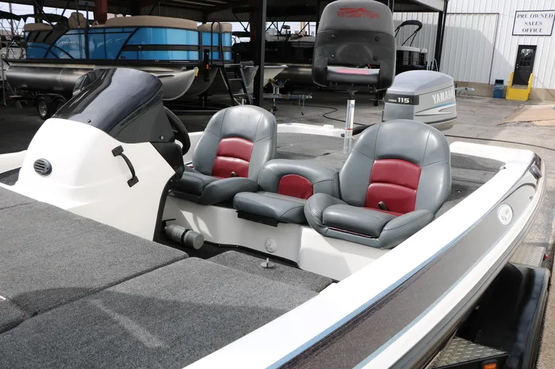 Slide: The Image of 2007 Skeeter SX180 boat interior with dual seats and console, parked in a marina. - 24