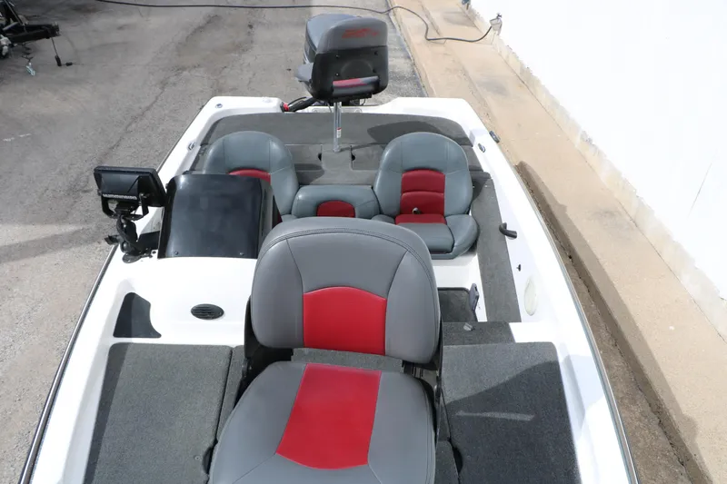 Slide: The Image of 2007 Skeeter SX180 boat interior with gray and red seating, featuring a control panel and motor. - 26