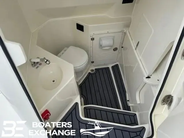 Slide: The Image of Interior of 2026 Cobia 285 Open Center Console with toilet and sink. - 7