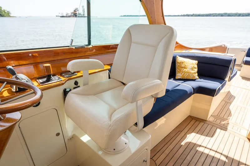 Slide: The Image of Luxurious interior of 2013 Hinckley Talaria 34 yacht with plush seating and wooden accents. - 10