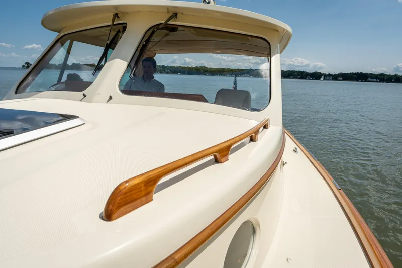 Slide: The Image of 2013 Hinckley Talaria 34 cruising on a calm lake under a clear blue sky. - 17