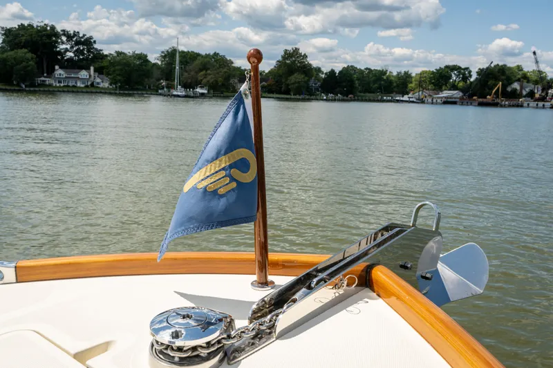 Slide: The Image of Hinckley Talaria 34 boat bow with flag, anchor, and scenic water view, 2013 model. - 19