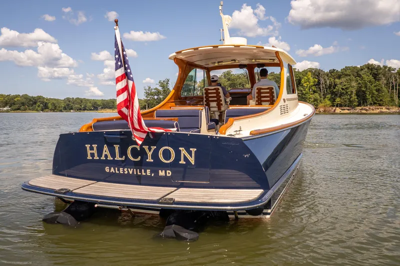 Slide: The Image of 2013 Hinckley Talaria 34 boat named "Halcyon" on water, Galesville, MD, with American flag. - 21