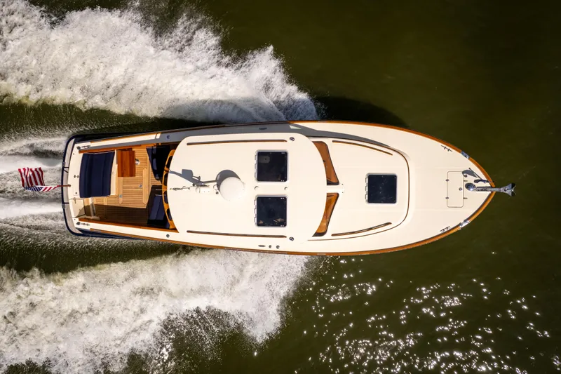 Slide: The Image of 2013 Hinckley Talaria 34 yacht cruising on water, aerial view. - 3