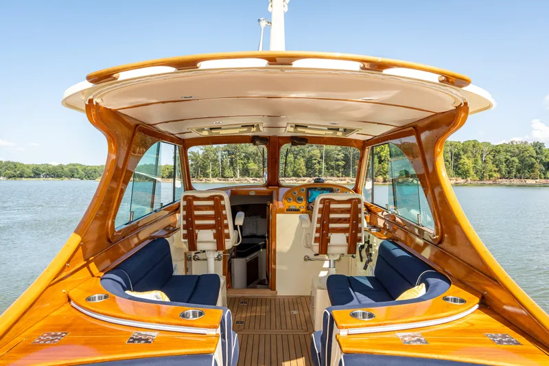Slide: The Image of 2013 Hinckley Talaria 34 yacht interior with wooden finish and blue seating on a sunny day. - 5