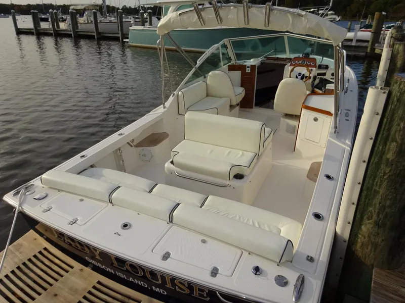 Slide: The Image of 2008 Hunt Yachts Harrier 25 docked, featuring spacious seating and elegant design. - 12