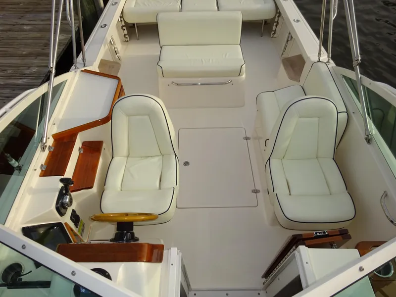 Slide: The Image of 2008 Hunt Yachts Harrier 25 interior with white seating and wooden accents. - 15