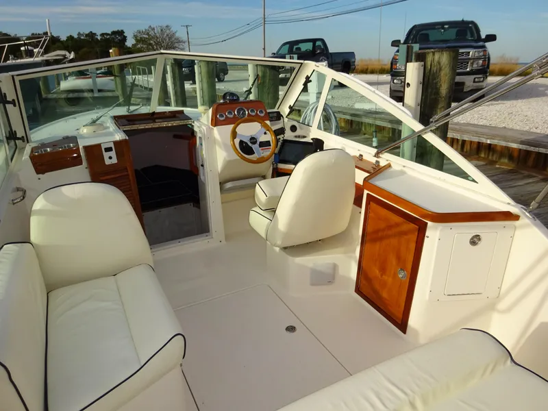 Slide: The Image of 2008 Hunt Yachts Harrier 25 interior with white seating and wooden accents. - 19