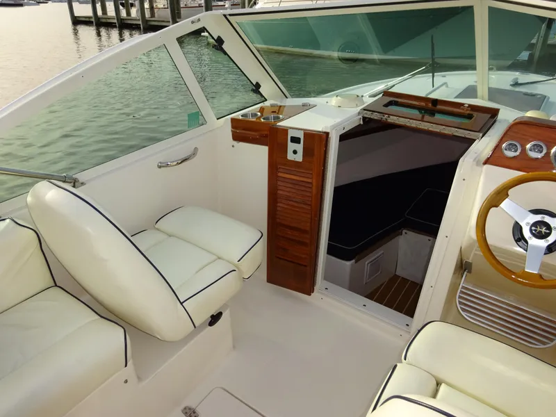 Slide: The Image of 2008 Hunt Yachts Harrier 25 interior with white seating and wooden accents. - 22