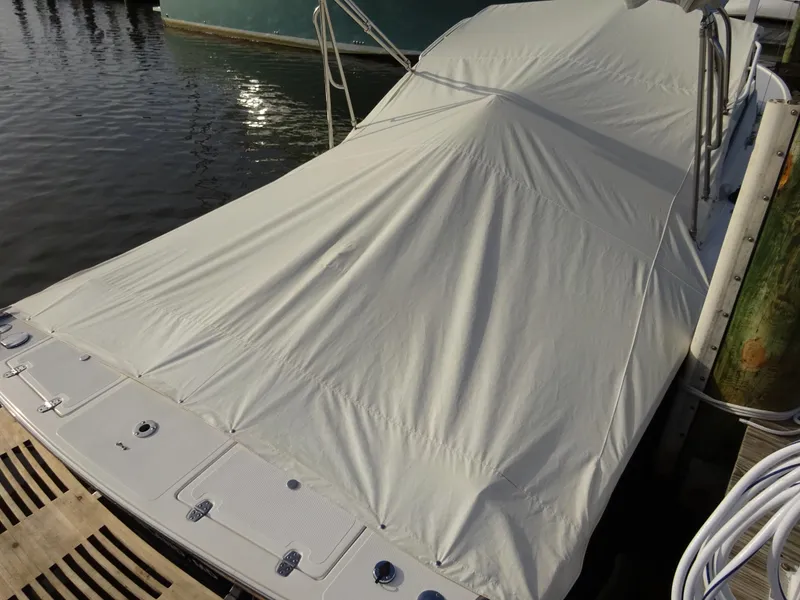 Slide: The Image of Covered 2008 Hunt Yachts Harrier 25 docked by the water. - 34