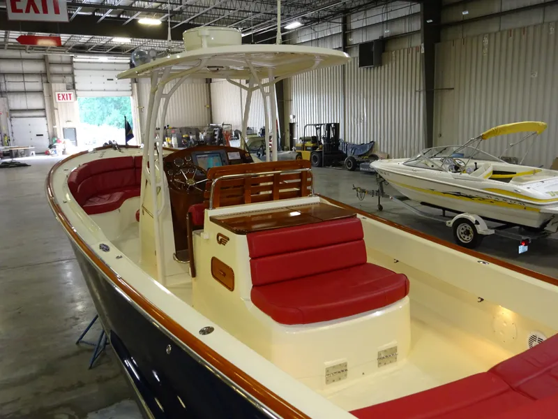 Slide: The Image of 2007 Hinckley T29C boat with red seating, displayed indoors. - 1