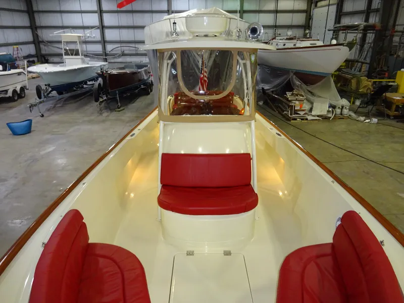 Slide: The Image of 2007 Hinckley T29C boat with red seating in a storage facility. - 22