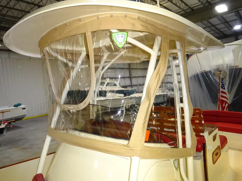 Slide: The Image of 2007 Hinckley T29C boat with clear enclosure in a storage facility. - 35
