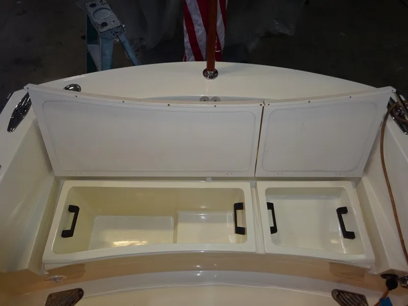 Slide: The Image of 2007 Hinckley T29C boat storage compartments with open lids, showcasing interior space. - 41