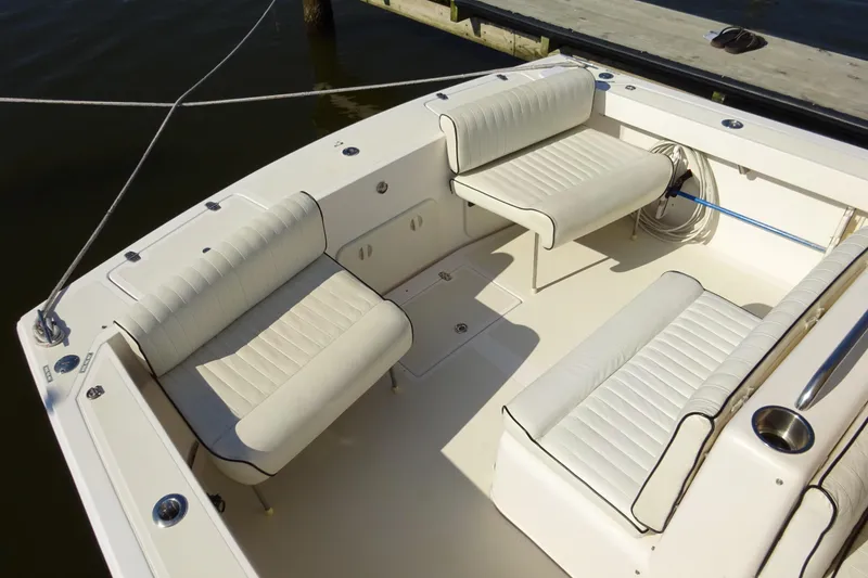 Slide: The Image of 2007 Hunt Yachts Surfhunter 29 interior with white cushioned seating and deck view. - 13