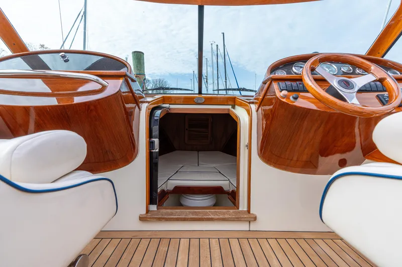 Slide: The Image of Interior view of 2006 Hinckley Talaria 29 R yacht with wooden dashboard and seating. - 12