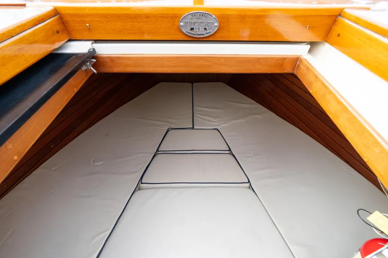 Slide: The Image of 2006 Hinckley Talaria 29 R cabin interior with wooden trim and cushioned seating. - 13