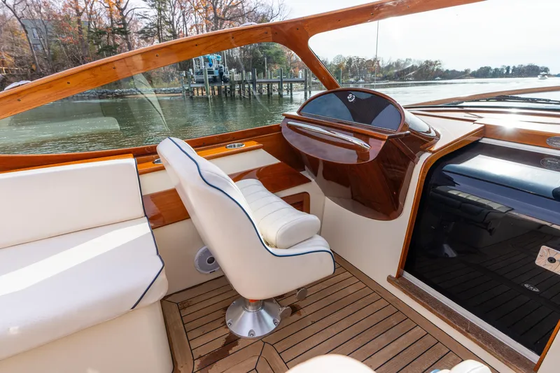 Slide: The Image of 2006 Hinckley Talaria 29 R interior with elegant wood and white seating. - 8