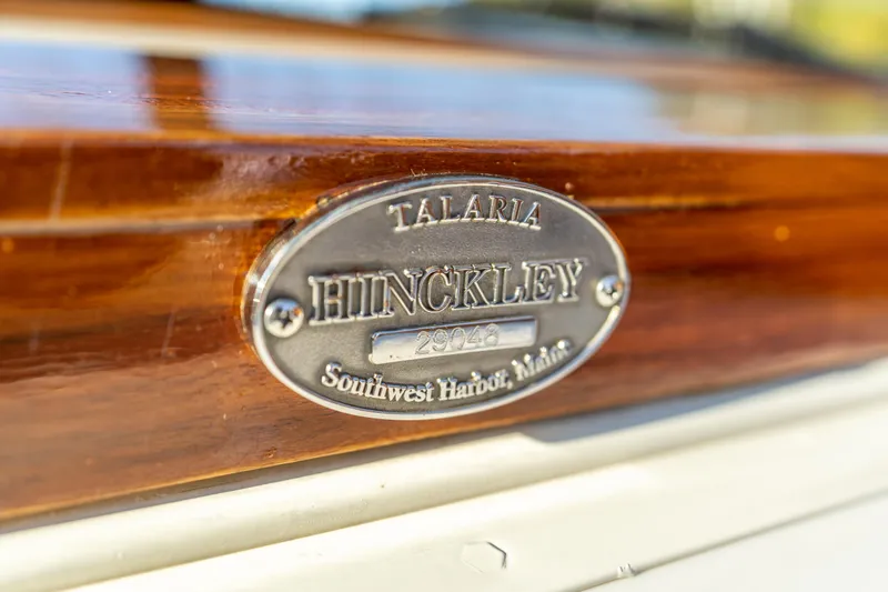 Slide: The Image of Hinckley Talaria 29 Runabout 2003 nameplate, Southwest Harbor, Maine, on polished wood surface. - 10