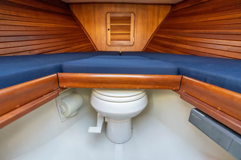 Slide: The Image of 2003 Hinckley Talaria 29 Runabout interior with wooden finish and marine toilet. - 19