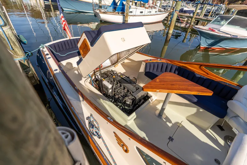 Slide: The Image of 2003 Hinckley Talaria 29 Runabout with open engine compartment, docked at marina. - 21