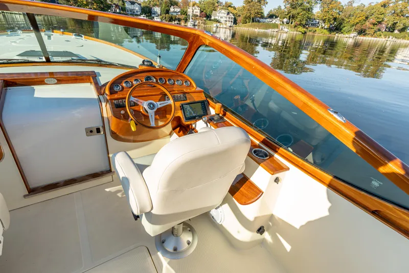 Slide: The Image of 2003 Hinckley Talaria 29 Runabout cockpit with wooden dashboard and white captain's chair. - 5