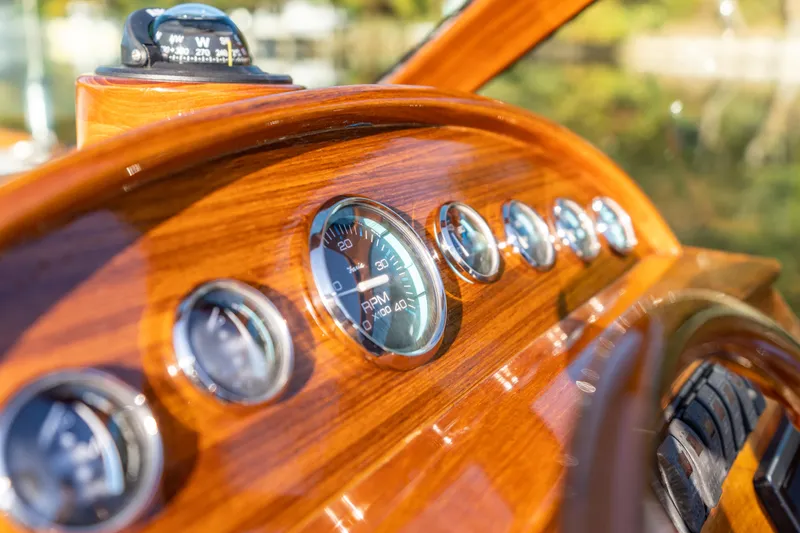 Slide: The Image of Dashboard of 2003 Hinckley Talaria 29 Runabout with wooden finish and gauges. - 8