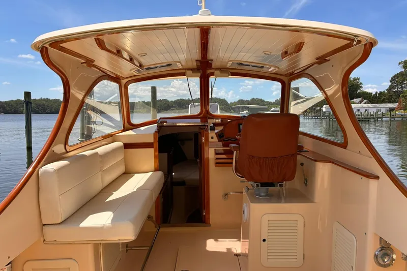 Slide: The Image of Interior view of a 1995 Hinckley Picnic Boat 36 Classic, featuring elegant seating and helm. - 16