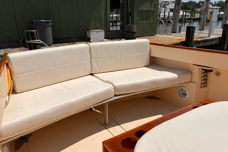 Slide: The Image of Hinckley Picnic Boat 36 Classic 1995 with cream seating at dockside. - 17