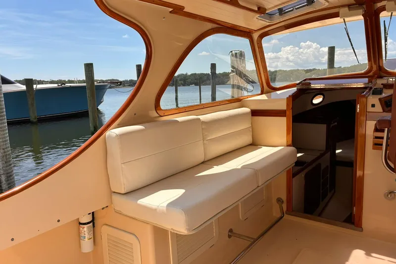 Slide: The Image of Interior of 1995 Hinckley Picnic Boat 36 Classic with cream seating and wooden accents. - 18