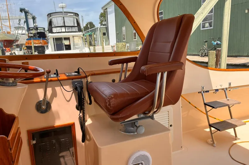 Slide: The Image of Captain's chair in 1995 Hinckley Picnic Boat 36 Classic, docked at marina. - 19